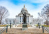 Capitol building with statue in foreground.