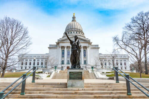 wisconsin-state1172506678 Capitol building with statue in foreground.