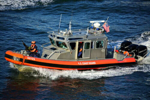 U.S. Coast Guard boat speeding on water.