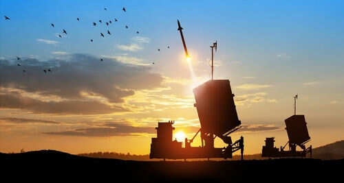 2382852601 Missile launching at sunset with birds flying nearby.