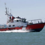 Red and white coast guard boat on ocean water