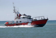 Red and white coast guard boat on ocean water