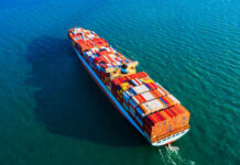 Cargo ship sailing on blue ocean water