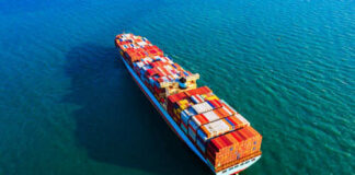 Cargo ship sailing on blue ocean water