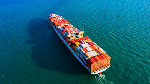 Cargo ship sailing on blue ocean water