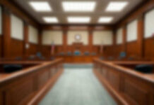 Empty blurred courtroom with wooden interior usa flags