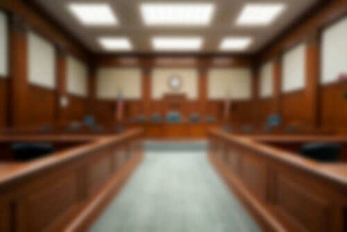 Empty blurred courtroom with wooden interior usa flags