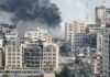 City buildings with heavy smoke and extensive war damage