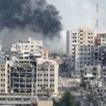 City buildings with heavy smoke and extensive war damage