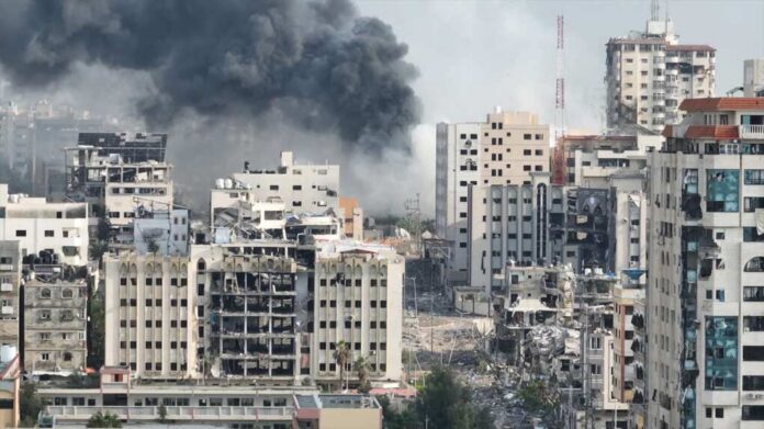 Smoke,Rising,Behind,Destroyed,Buildings,In,Gaza,,Aerial,View,Drone City buildings with heavy smoke and extensive war damage