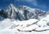 Snowy mountain landscape with wooden walking paths tourists