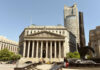 Neoclassical courthouse with tall columns and nearby modern tower