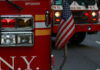 Fire trucks with American flag, New York City.