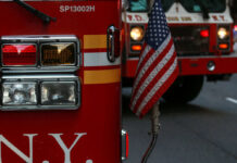 Fire trucks with American flag, New York City.