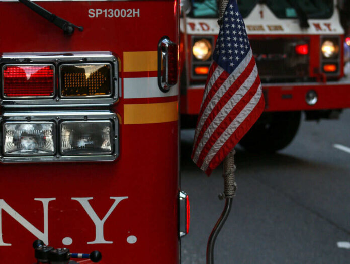 Fire trucks with American flag, New York City.