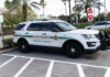 Inflated Arrests? Florida’s Numbers Don’t Add Up Sheriff SUV parked in a lot near palm trees