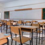 NYC Schools Face $7B Black Hole An empty classroom with wooden desks and a chalkboard