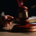 Judge DEFIES Defense — Kirk Trial Goes LIVE A wooden gavel resting on a table with a blurred hand in the background