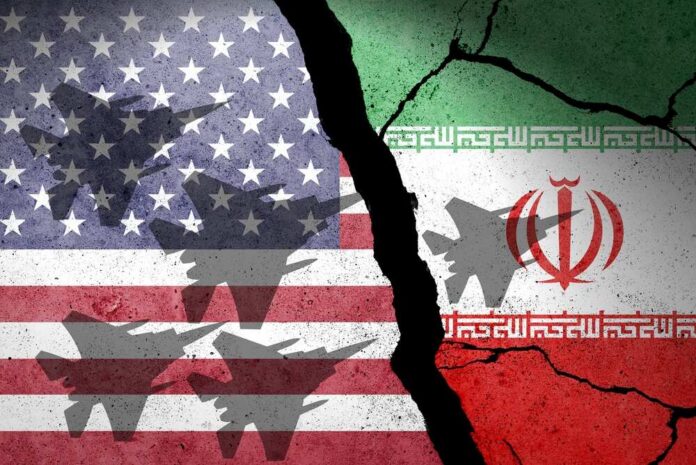 shutterstock_2748415895.jpg A cracked wall featuring the flags of the United States and Iran, with military aircraft silhouettes