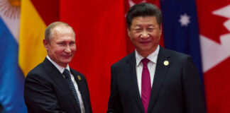 Two international leaders shaking hands at a diplomatic event