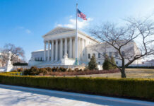 United States Supreme Court building with flag and columns