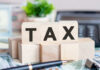 DeSantis Torches Property Tax Bills Wooden blocks spelling tax on desk background