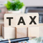 DeSantis Torches Property Tax Bills Wooden blocks spelling tax on desk background