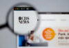 CBS News website viewed through a magnifying glass.