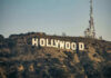 Hollywood ‘Witchcraft’ Pokes Big Pharma Hollywood sign with communication tower on hillside.