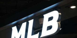 Illuminated MLB sign on a dark ceiling