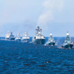 Ceasefire Chaos: Who Hit That Ship? A fleet of warships sailing in formation on the ocean