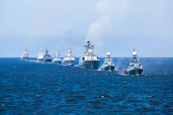 A fleet of warships sailing in formation on the ocean