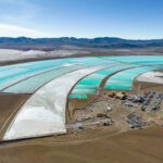 Sun-Powered Desalination Upends Waste Rules Aerial view of turquoise evaporation ponds and industrial site in a desert basin