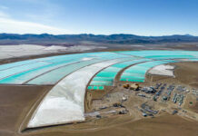 Sun-Powered Desalination Upends Waste Rules Aerial view of turquoise evaporation ponds and industrial site in a desert basin