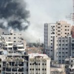 Intel Claims Collide With Shattered Wards A view of destroyed buildings with smoke rising in the background