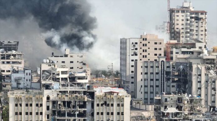 Smoke,Rising,Behind,Destroyed,Buildings,In,Gaza,,Aerial,View,Drone A view of destroyed buildings with smoke rising in the background
