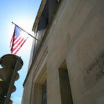 Critical Spy Warning—Washington Stays Quiet United States flag Department of Justice building exterior