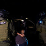 Viral Courthouse Arrest Sparks Records Blackout Two armed officers detaining person at night