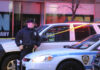 Harlem Subway Horror — Predator Still Loose Police officer standing near a crime scene with vehicles and caution tape