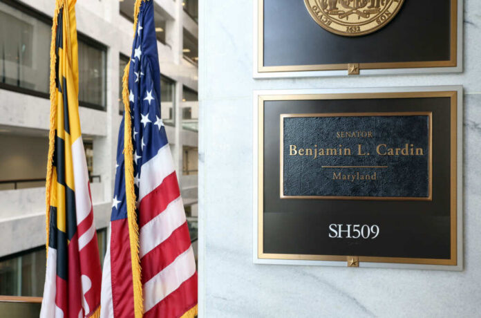 office-entrance-ben-cardin743195380jpg Office plaque beside U.S. and state flags in a government building