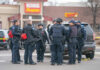 Gas Station SLAUGHTER Stuns Louisiana Police officers in tactical gear gather near a patrol SUV