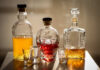 A collection of decorative liquor bottles and shot glasses on a table