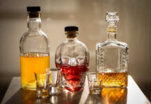 Moderate Drinking’s NASTY Catch A collection of decorative liquor bottles and shot glasses on a table