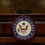 Rage Over USAID Shutdown, Facts MIA Podium with the United States Senate seal