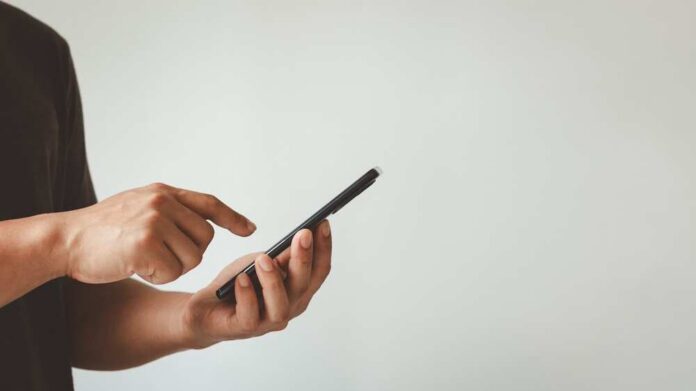 Young,Man,Hand,Holding,Smartphone,For,Calls,,Social,Media,,Mobile Person using a smartphone with one hand