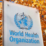 World Health Organization sign with autumn leaves background