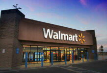 Walmart storefront at dusk with lit signage