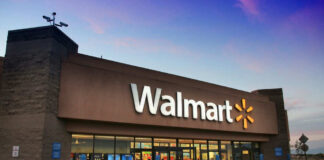 Walmart storefront at dusk with lit signage