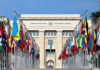 U.N. Meltdown: U.S. Bolts On France United Nations building with numerous national flags outside.