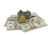 Model house on scattered US dollar bills